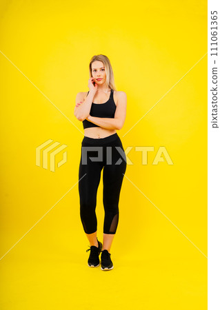 Happy fit woman over studio background. Smiling female fitness workout. Healthy lifestyle concept. Happy fit woman over studio background. Smiling female fitness workout. Healthy lifestyle concept. 111061365