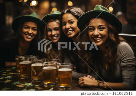 A group of young women in green hats relaxing in a beer bar. 111062511