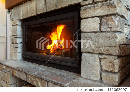 Stone Fireplace with burning fire, Cozy Winter Stone Fireplace with burning fire, Cozy Winter 111062697