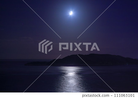 Moon in the dark sky over the island and sea Moon in the dark sky over the island and sea 111063101
