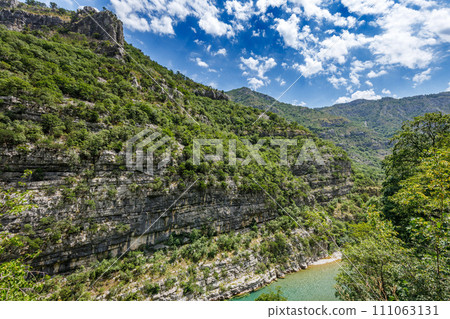 Canyon of the Tara river in mountains of Montenegro covered with green woods Canyon of the Tara river in mountains of Montenegro covered with green woods 111063131