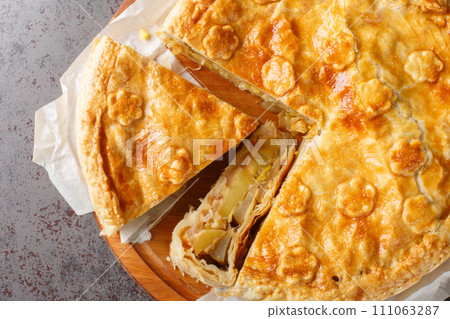 Fruit and vegetable Swiss cholera pie with apple, potato, pear, onion and cheese close-up on a wooden board. Horizontal top view Fruit and vegetable Swiss cholera pie with apple, potato, pear, onion and cheese close-up on a wooden board. Horizontal top view 111063287