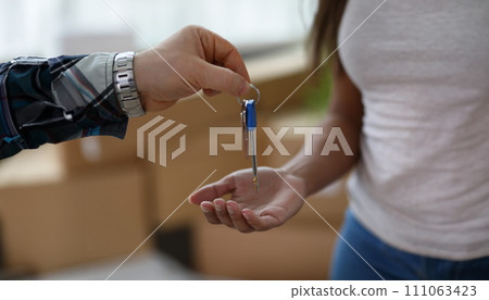 Man gives woman keys to apartment, rental property Man gives woman keys to apartment, rental property 111063423