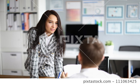 Woman puts pressure on man sitting in front her Woman puts pressure on man sitting in front her 111063425