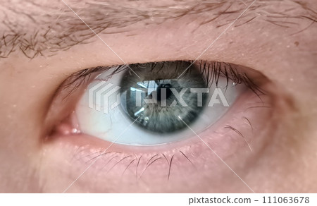 Close up young mans eye, look from under eyelids Close up young mans eye, look from under eyelids 111063678