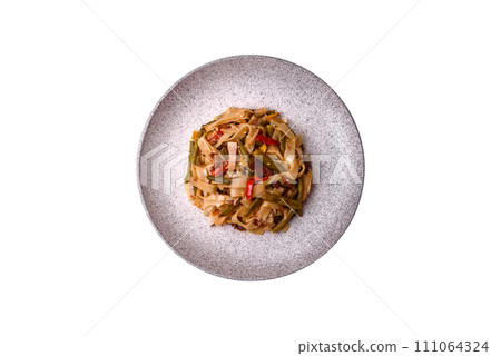 Delicious Asian dish udon with hot peppers, green beans, spices and herbs 111064324