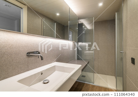 Shower cabin and wash basin in renovated bathroom with mirror Shower cabin and wash basin in renovated bathroom with mirror 111064340
