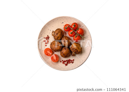 Delicious juicy whole champignons baked on the grill with salt and spices Delicious juicy whole champignons baked on the grill with salt and spices 111064341