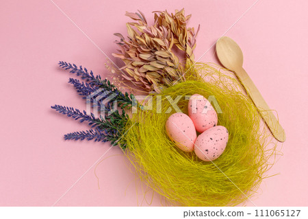 Nest with pink Easter eggs on the pink background. Nest with pink Easter eggs on the pink background. 111065127