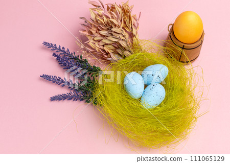 Nest with colored Easter eggs on the pink background. Nest with colored Easter eggs on the pink background. 111065129
