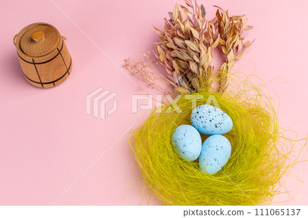 Nest with colored Easter eggs on the pink background. Nest with colored Easter eggs on the pink background. 111065137