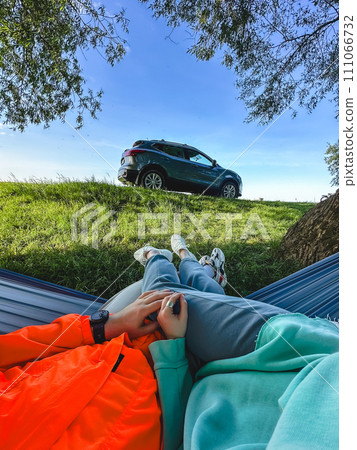 pov couple laying down in hammock outdoors under the tree pov couple laying down in hammock outdoors under the tree 111066732