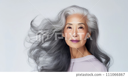 AI-generated content. Smiling, elderly, chic Asian woman with gray long hair and perfect skin, on a white background, banner. 111066867