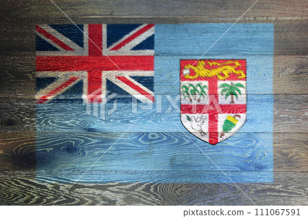 Fiji flag on rustic old wood surface background Fiji flag on rustic old wood surface background 111067591