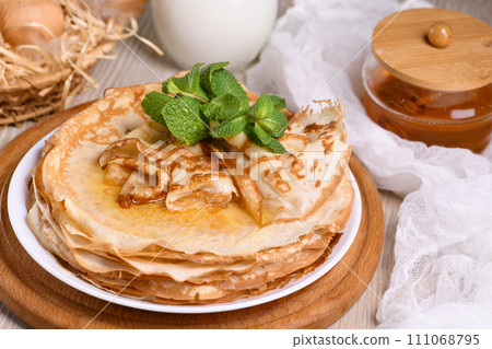 Homemade thin crepe (pancakes) with honey 111068795