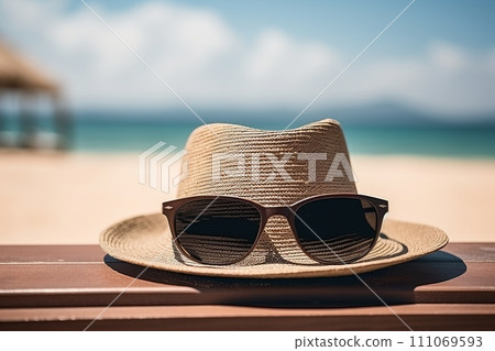 beach holiday. stylish hat and sunglasses on sandy shore, embodying the perfect vacation vibe 111069593