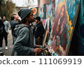 AI-generated content. Black refugee artist paints picture on street surrounded by graffiti on walls. Street art concept AI-generated content. Black refugee artist paints picture on street surrounded by graffiti on walls. Street art concept 111069919