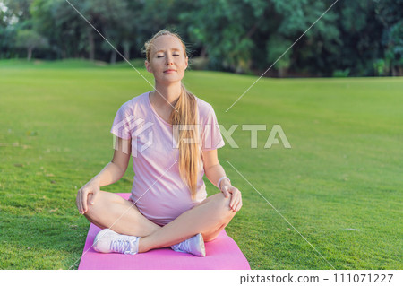 Energetic pregnant woman takes her workout outdoors, using an exercise mat for a refreshing and health-conscious outdoor exercise session Energetic pregnant woman takes her workout outdoors, using an exercise mat for a refreshing and health-conscious outdoor exercise session 111071227