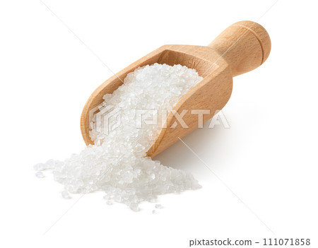 Salt crystals in a small wooden scoop isolated on white background 111071858