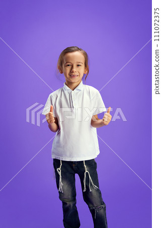 Happy, smiling little boy showing thumb up, like sign against purple background. Human positive emotions. Celebration national holidays. 111072375
