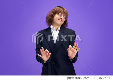 Portrait f charismatic man looks at camera and expressed that everything will be fine looking at camera and gesturing Ok sign. Portrait f charismatic man looks at camera and expressed that everything will be fine looking at camera and gesturing Ok sign. 111072387