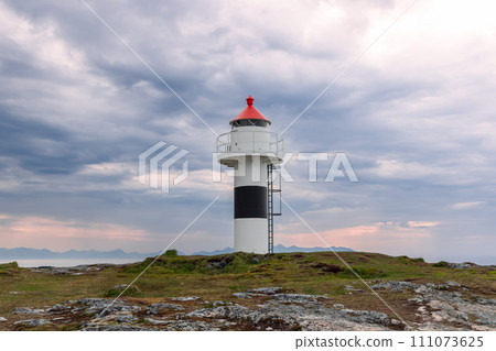 Red-capped Borhella Lighthouse contrasts with moody clouds 111073625