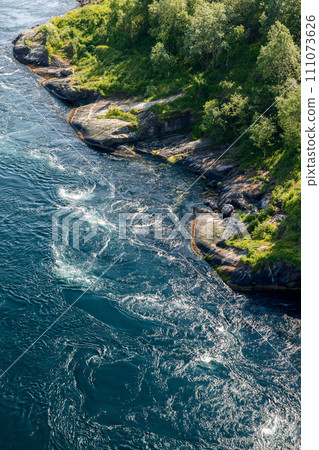Aerial view of Saltstraumen's whirlpools and green shoreline 111073626