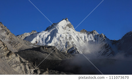 Blue sky over a high mountain. Late afternoon scene seen from Gorakshep, Nepal. 111073670
