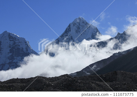 Mount Cholatse surrounded by autumn fog. View from Gorakshep, Nepal. 111073775