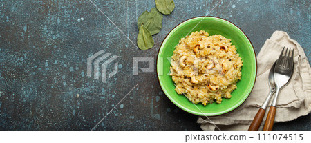 Ven Pongal (Khara Pongal), traditional Indian savoury rice dish made during celebrating Pongal festival, served in bowl top view on concrete rustic background, space for text 111074515