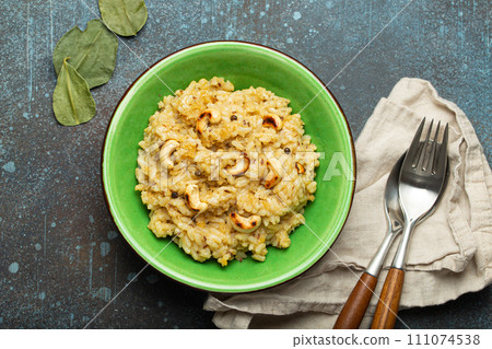 Ven Pongal (Khara Pongal), traditional Indian savoury rice dish made during celebrating Pongal festival, served in bowl top view on concrete rustic background 111074538