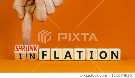 Inflation or shrinkflation symbol. Concept words Inflation Shrinkflation on beautiful wooden blocks. Beautiful orange background. Businessman hand. Business inflation shrinkflation concept. Copy space Inflation or shrinkflation symbol. Concept words Inflation Shrinkflation on beautiful wooden blocks. Beautiful orange background. Businessman hand. Business inflation shrinkflation concept. Copy space 111074620