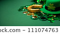 St. Patrick's Day Leprechaun Hat, Gold Coins, Shamrocks and Party Favors on Green Background. 111074763