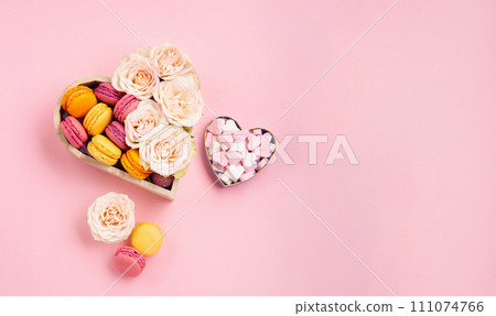 Cookies Macaroons in Gift Box, Rose Flowers and Candies on Pink Background. Holiday Presents Concept Cookies Macaroons in Gift Box, Rose Flowers and Candies on Pink Background. Holiday Presents Concept 111074766