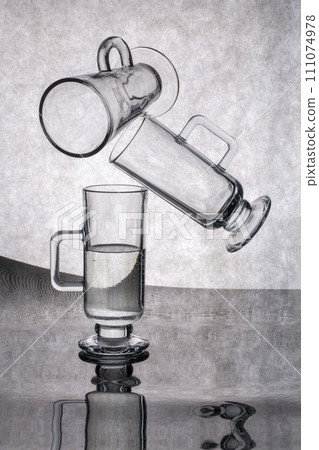 Still life with glassware on a reflective surface 111074978