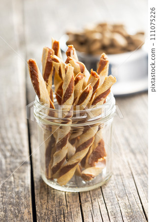 Dog food. Snack sticks for dogs on wooden table. 111075226