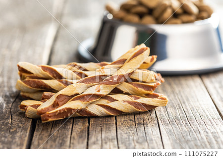 Dog food. Snack sticks for dogs on wooden table. 111075227