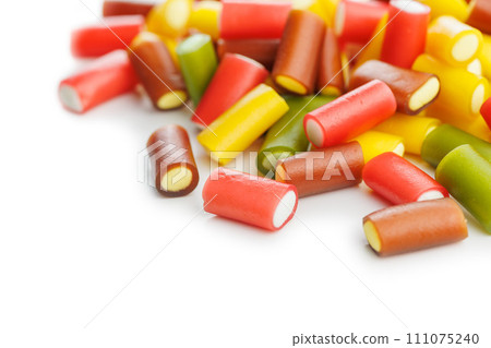 Sweet colorful chewy candy sticks isolated on white background. Sweet colorful chewy candy sticks isolated on white background. 111075240