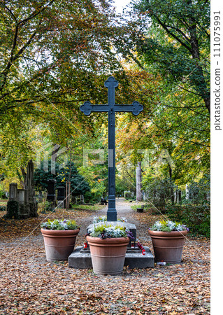Autumn view of famous Old North Cemetery of Munich, Germany with historic gravestones. 111075991