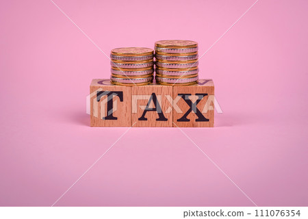 The inscription Tax made of wooden cubes on a plain background 111076354