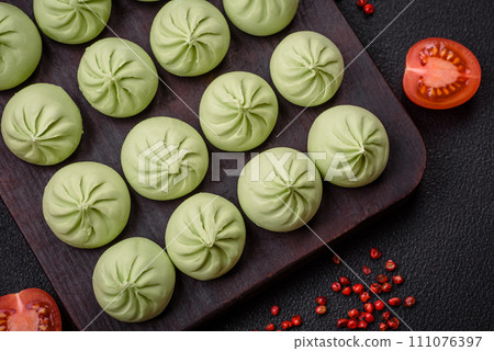 Raw khinkali or green dumplings with salt, spices and herbs Raw khinkali or green dumplings with salt, spices and herbs 111076397