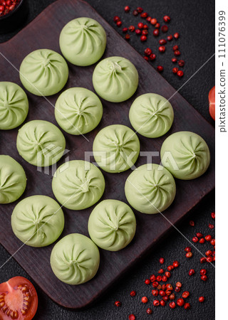 Raw khinkali or green dumplings with salt, spices and herbs Raw khinkali or green dumplings with salt, spices and herbs 111076399