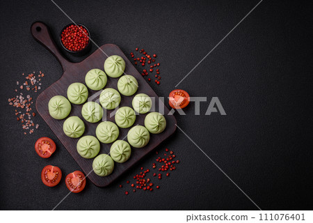 Raw khinkali or green dumplings with salt, spices and herbs Raw khinkali or green dumplings with salt, spices and herbs 111076401