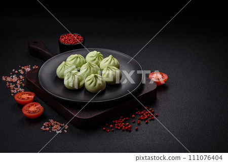 Raw khinkali or green dumplings with salt, spices and herbs Raw khinkali or green dumplings with salt, spices and herbs 111076404