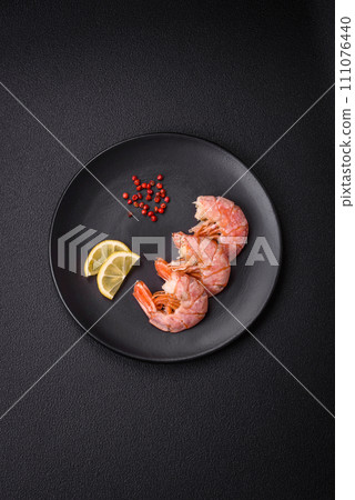 Delicious shrimp or langoustine tails boiled with salt and spices 111076440