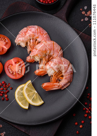 Delicious shrimp or langoustine tails boiled with salt and spices 111076448
