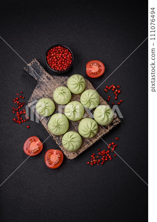 Raw khinkali or green dumplings with salt, spices and herbs Raw khinkali or green dumplings with salt, spices and herbs 111076494