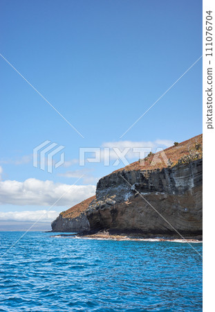 Cliff of an uninhabited island seen from the water, Galapagos National Park, Ecuador. Cliff of an uninhabited island seen from the water, Galapagos National Park, Ecuador. 111076704