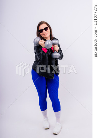 Young smiling happy chubby overweight plus size big fat fit woman warm up training hold dumbbells Young smiling happy chubby overweight plus size big fat fit woman warm up training hold dumbbells 111077278