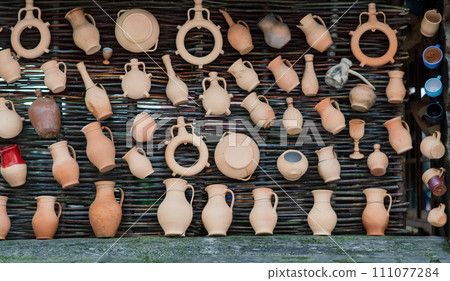 Ceramic clay terracotta jug, pot, vase, kitchen souvenirs in a handmade ceramics street store. 111077284